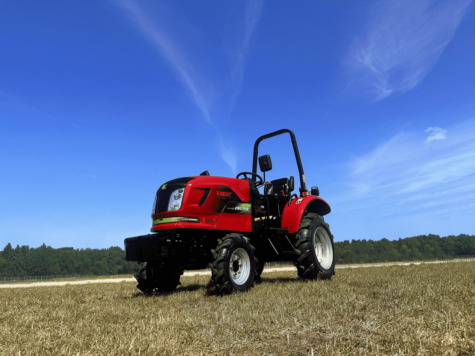 Electric tractor in a field at sunrise